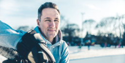 Father playing hockey outdoors